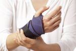 A woman has a bandage on her twisted wrist concept.