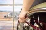 A man in a wheelchair after experiencing workers compensation for traveling employees.